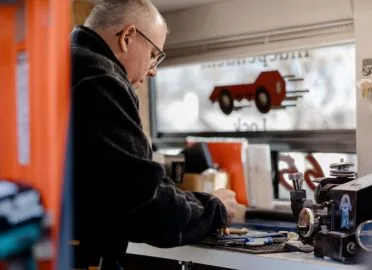 Doug McGrail, safe specialist at Independent Lock and Parts, working at the bench in the service van in Billings, MT