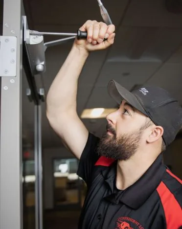 Quincy McGrail installing commercial door hardware for an access control system in Billings, MT